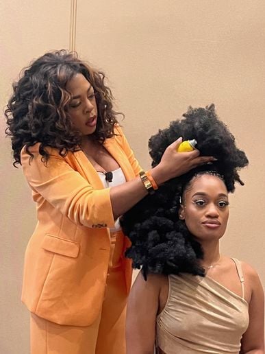 A hairstylist doing hair.