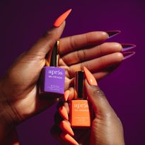 An orange and purple peekaboo nail look using the new Aprés Gel Couleurs.