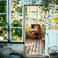 A chair inside a shack.