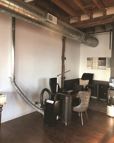 To vent to the outside, a source-capture system must be connected to ductwork, such as in this system in Cleveland’s Reign Salon.