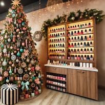 A Christmas tree in a nail salon.