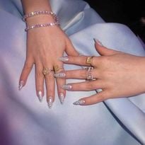 Hands with long fingernails and blue nail polish