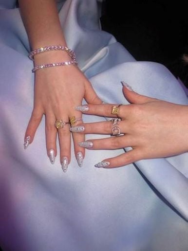 Hands with long fingernails and blue nail polish