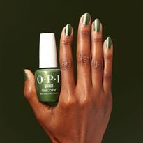 A hand holding a bottle of nail polish