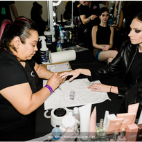 A nail technician uses the 1-minute disinfectant between models at this year's LAFW.