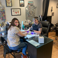 Nicole Franklin (right) with one of her first clients upon re-opening.